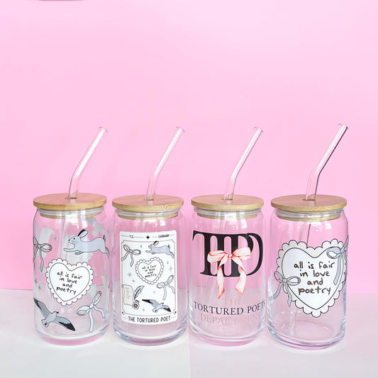 Glass tumblers featuring Taylor Swift's latest album 'TTPD,' showcasing vibrant and artistic designs