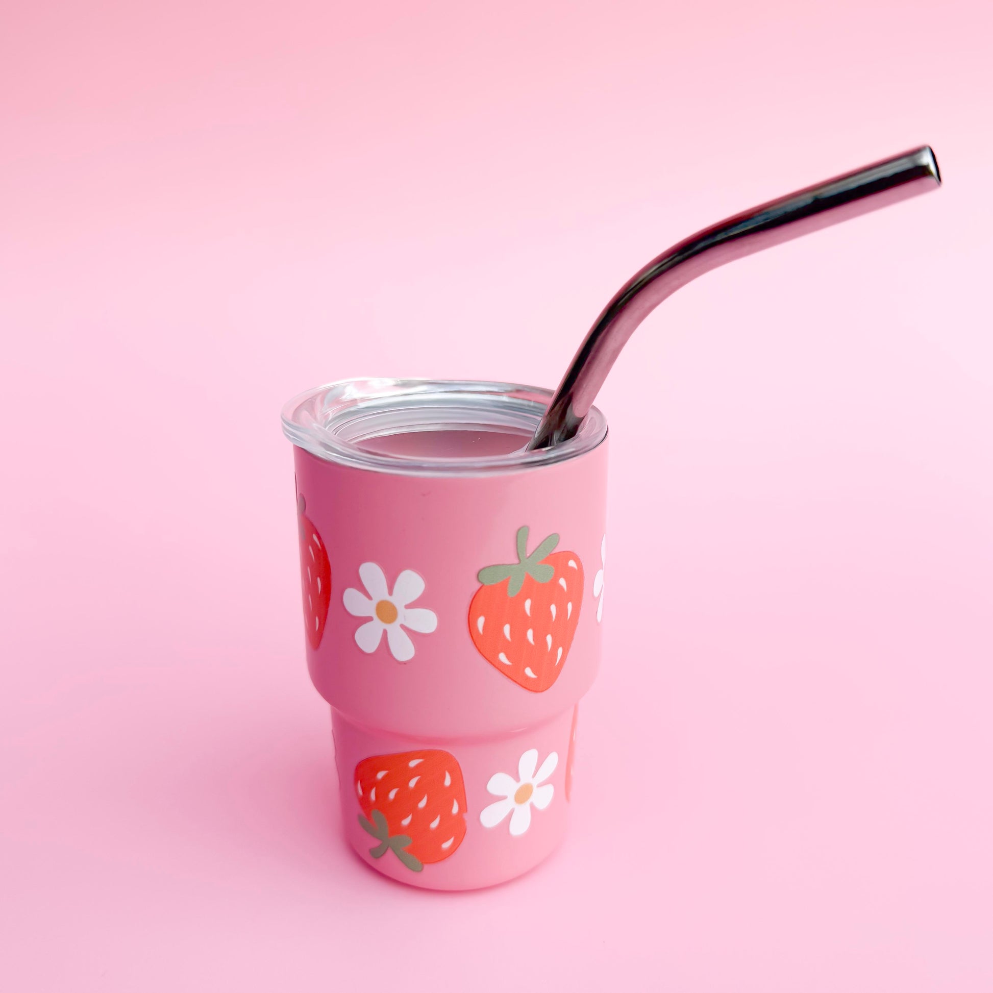 Small stainless steel pink cup with a red strawberries and mini daisies design, reusable straw, and spill-proof lid, ideal for Valentine’s Day gifts or party favors